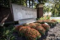 The front gate sign with beautiful mums.